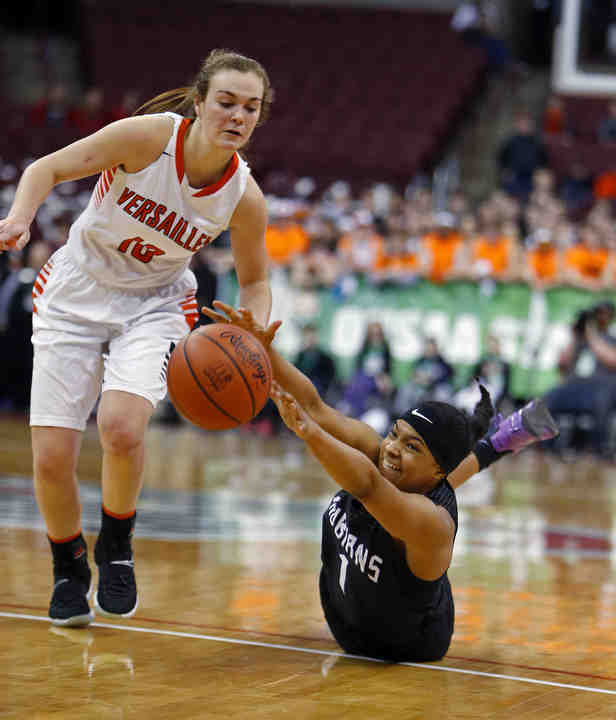 Africentric's Nyam Thornton (right) dives for the ball against Versailles Kami McEldoweney in the Division III state championship game at the Schottenstein Center in Columbus.    (Eric Albrecht / The Columbus Dispatch)